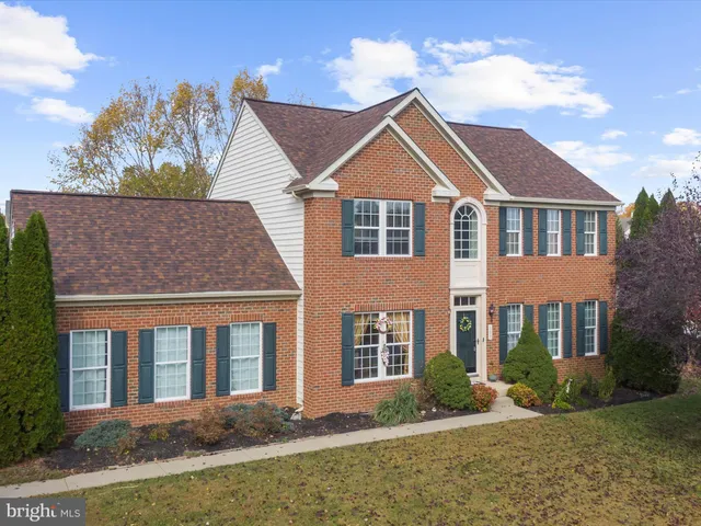 a view of a house with a yard and potted plants
