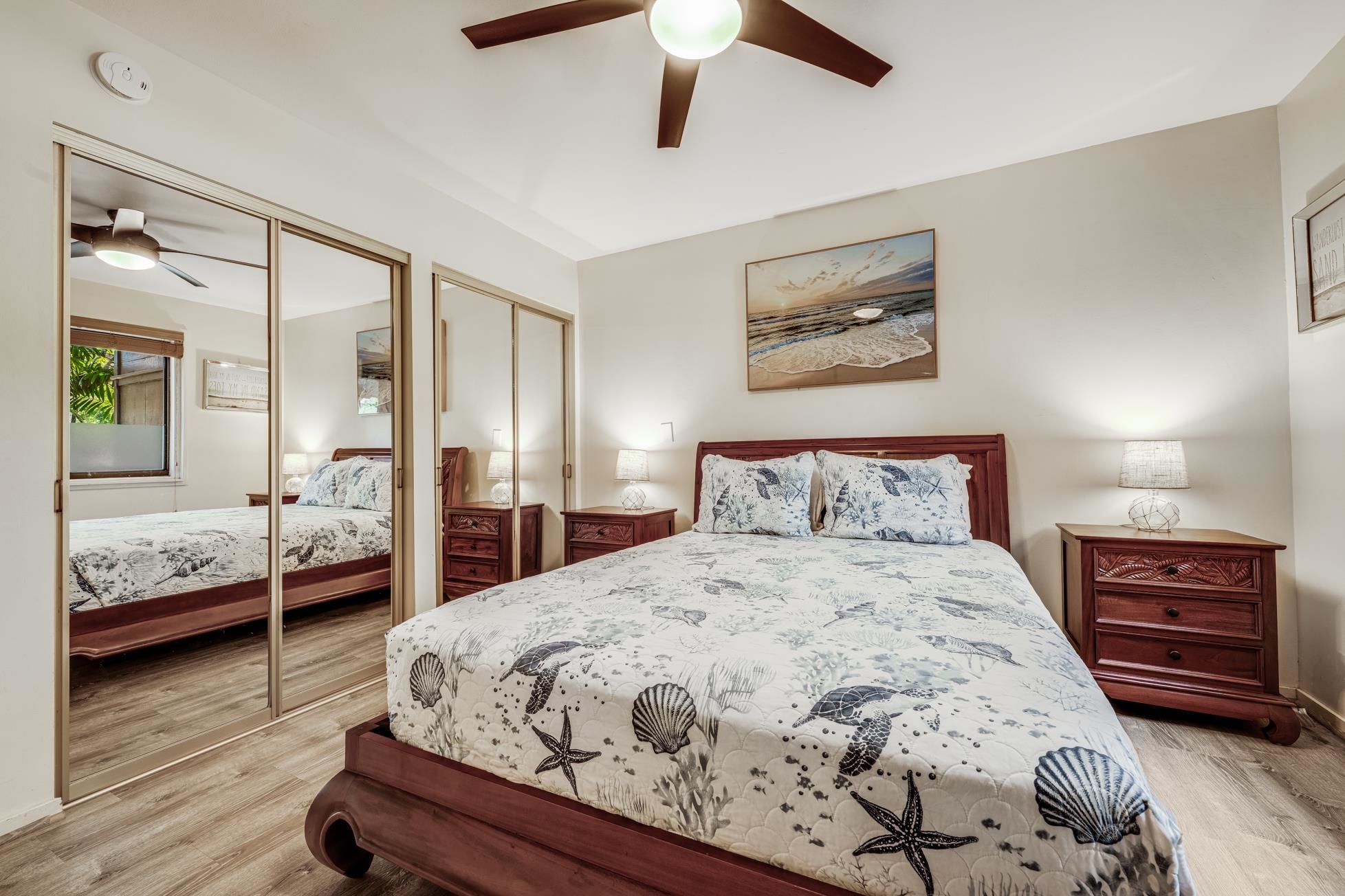 811 South Kihei Road, Unit 5D Kihei, HI 96753 - Photo 27 of 39 a bedroom with a bed and wooden floor