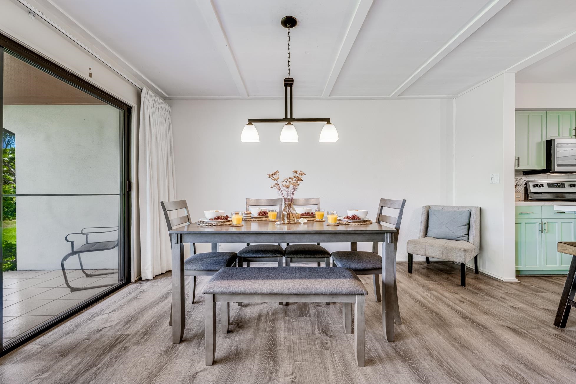 811 South Kihei Road, Unit 5D Kihei, HI 96753 - Photo 3 of 39 a view of a dining room with furniture wooden floor and chandelier