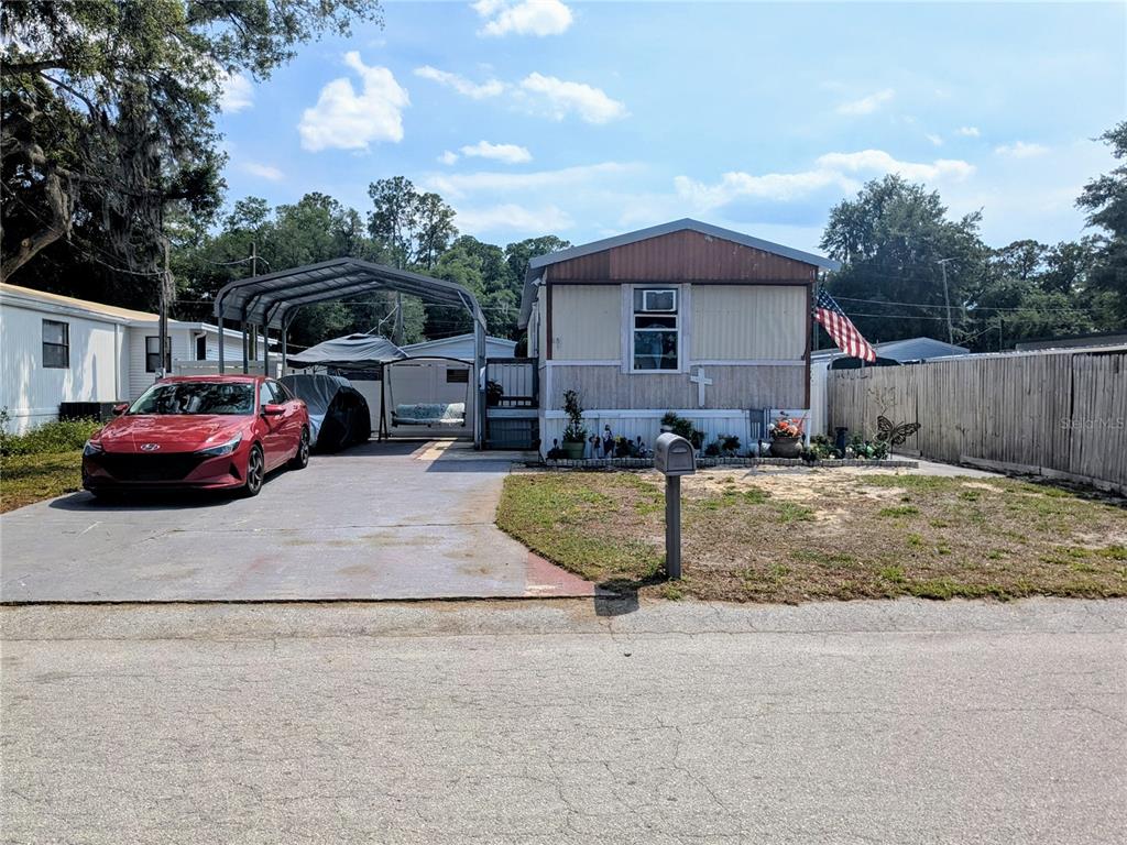a front view of a house with cars parked