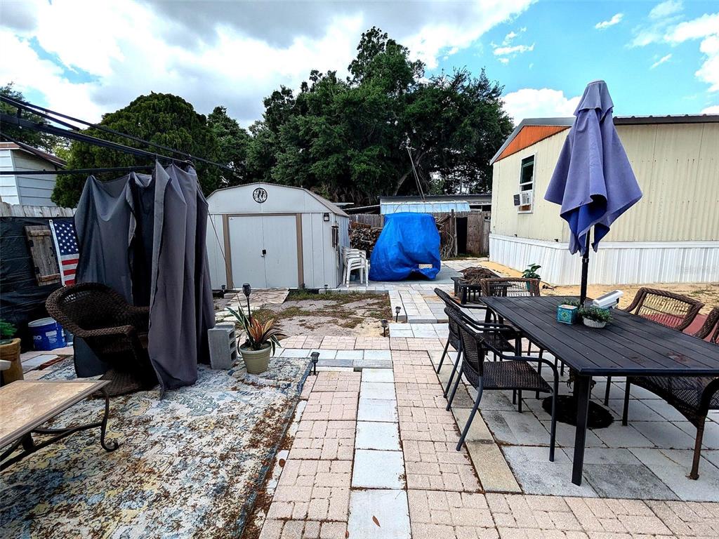 53 Sunset Circle Lake Alfred, FL 33850 - Photo 12 of 13 a view of a patio with a table and chairs