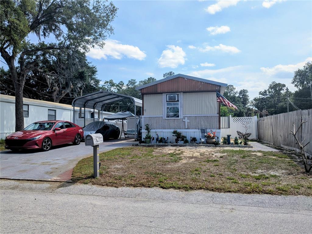 53 Sunset Circle Lake Alfred, FL 33850 - Photo 13 of 13 a view of a house with a yard and sitting area