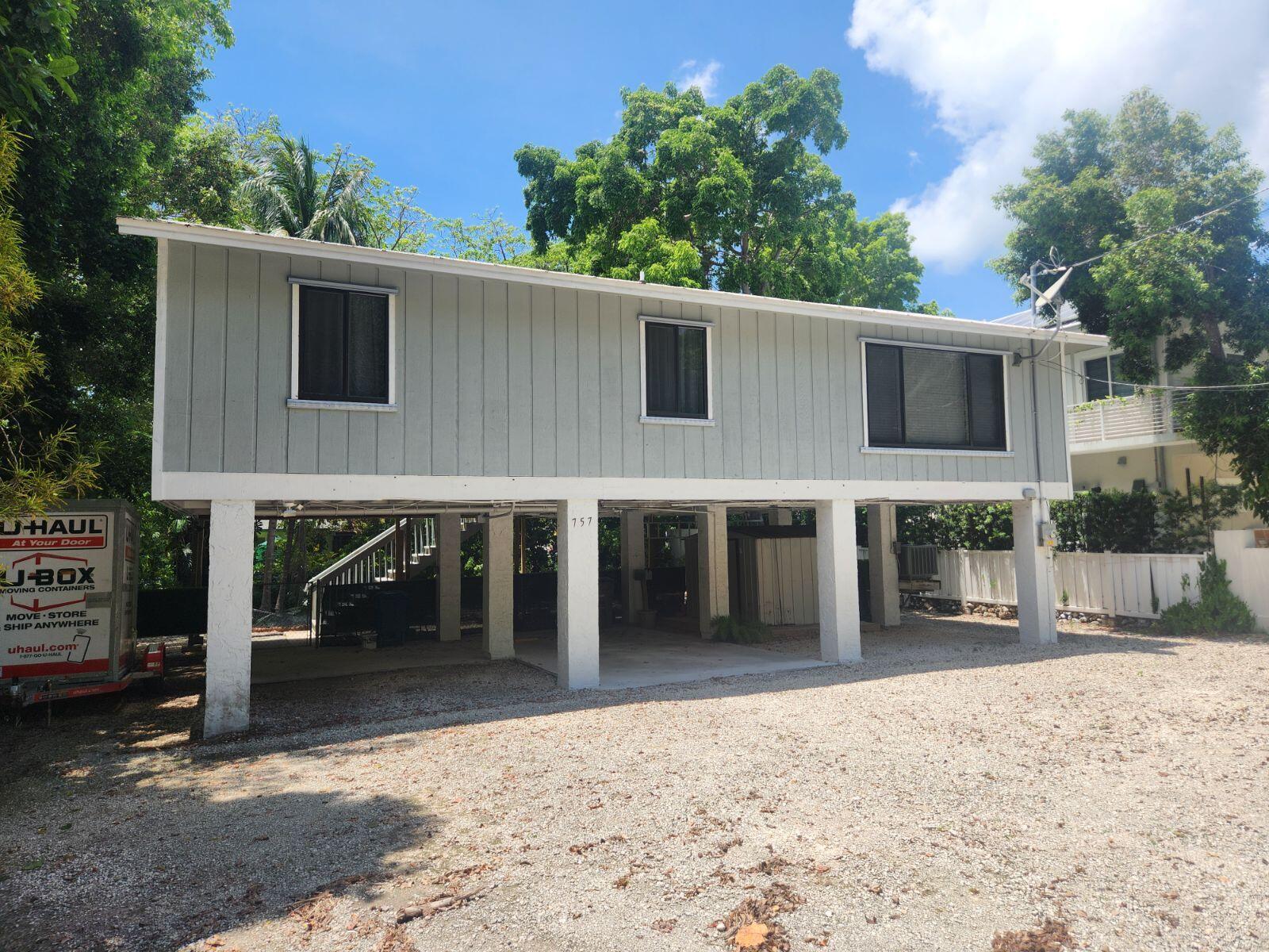 757 Musa Drive Key Largo, FL 33037 - Photo 1 of 20 a view of a house with a yard