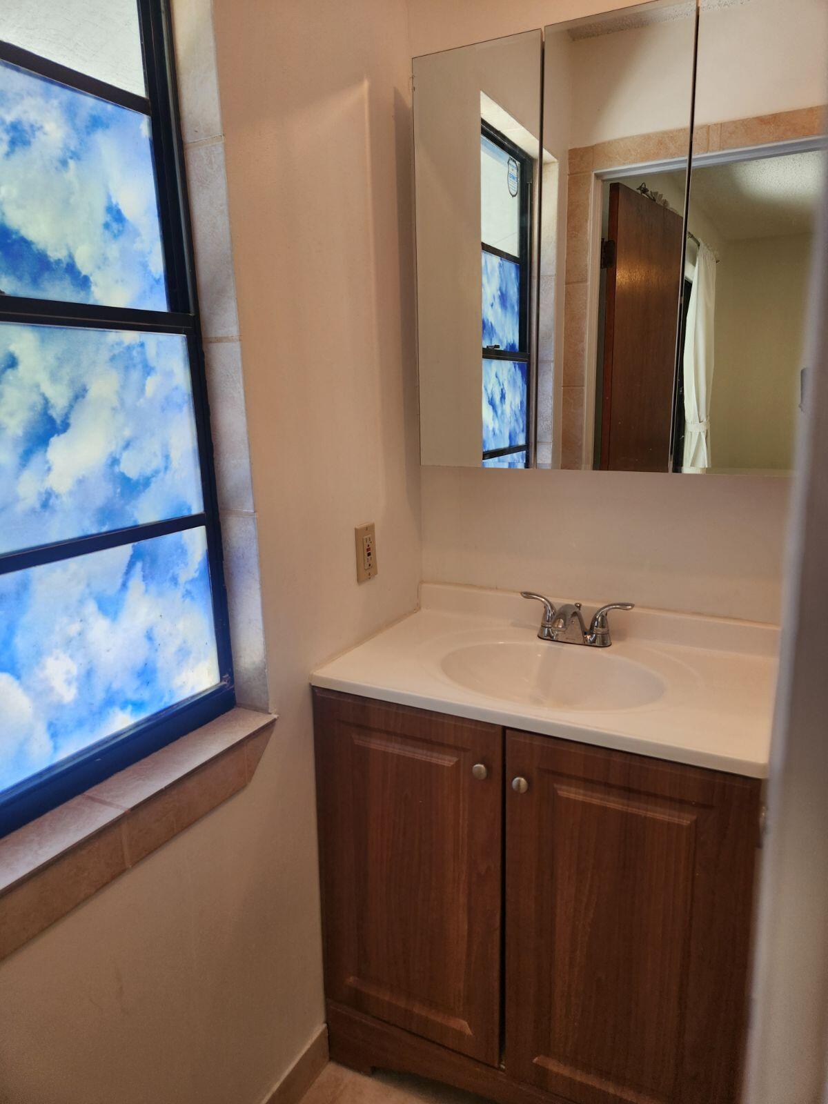 757 Musa Drive Key Largo, FL 33037 - Photo 10 of 20 a bathroom with a sink and a mirror
