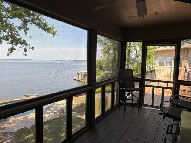 a view of a roof deck with dining table and chairs with wooden floor