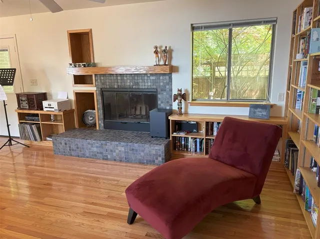 a living room with furniture a fireplace and a bookshelf