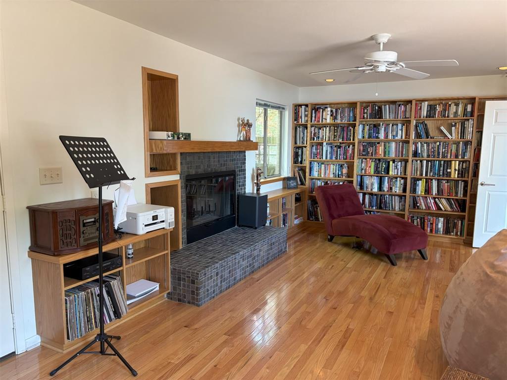 20998 Kiva Circle Flint, TX 75762 - Photo 17 of 40 a living room with furniture a fireplace and a bookshelf