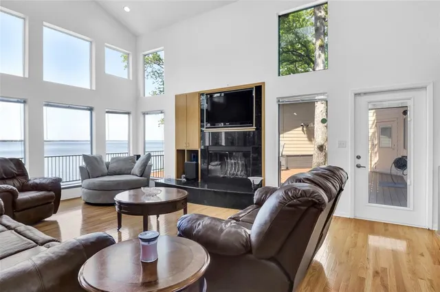 a living room with furniture kitchen view and a large window