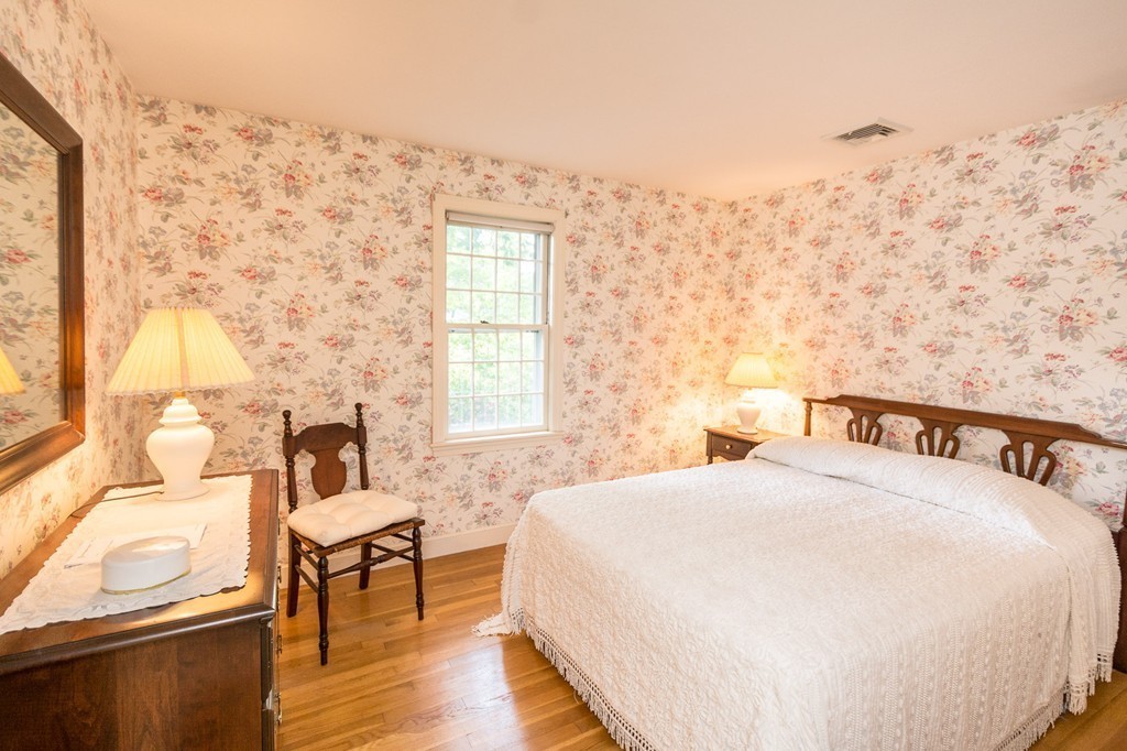 17 Haystack Lane Cohasset, MA 02025 - Photo 28 of 30 a bedroom with a bed and wooden floor