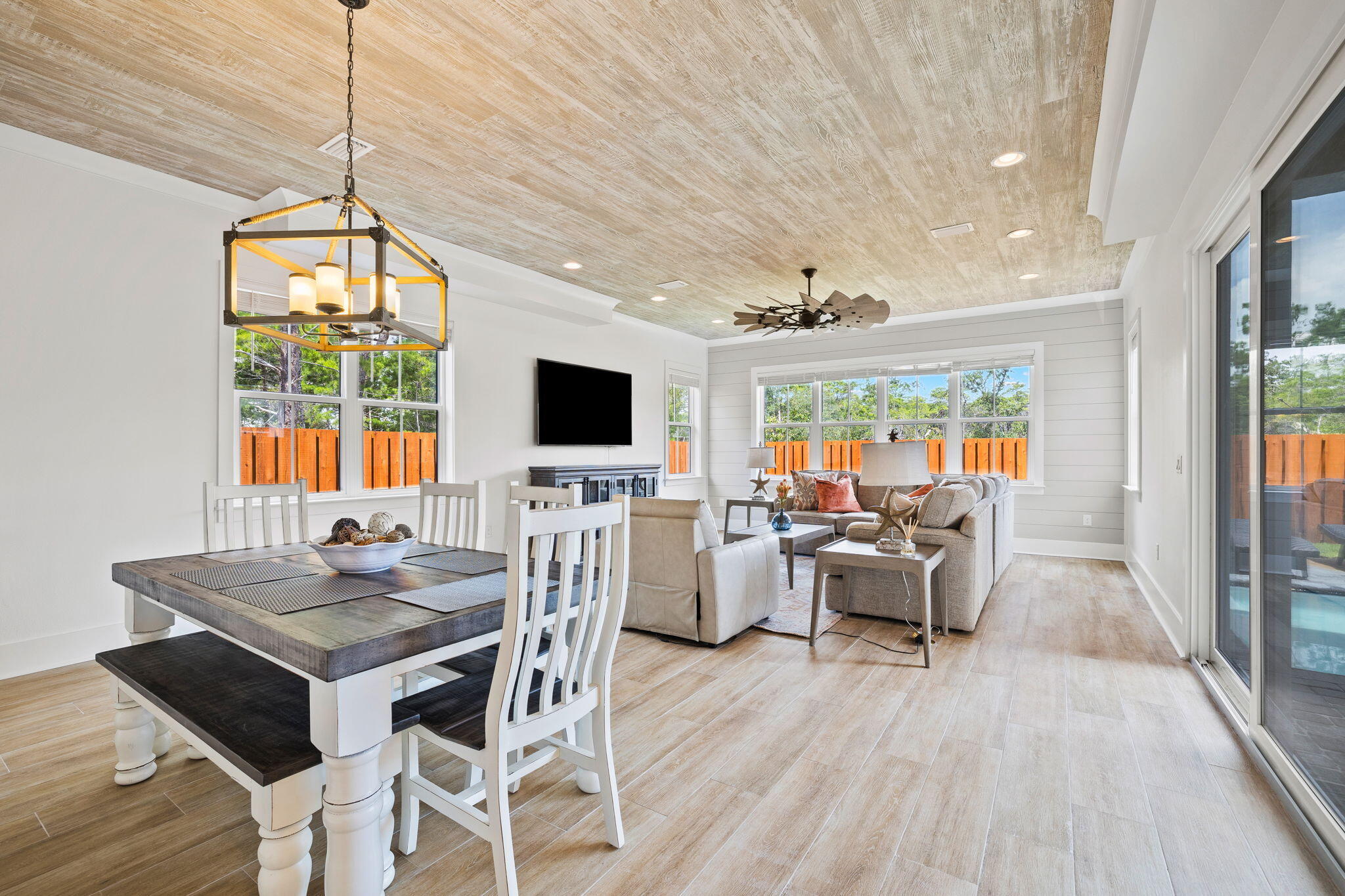 58 Carefree Lane Santa Rosa Beach, FL 32459 - Photo 11 of 44 a living room with furniture a flat screen tv and a floor to ceiling window