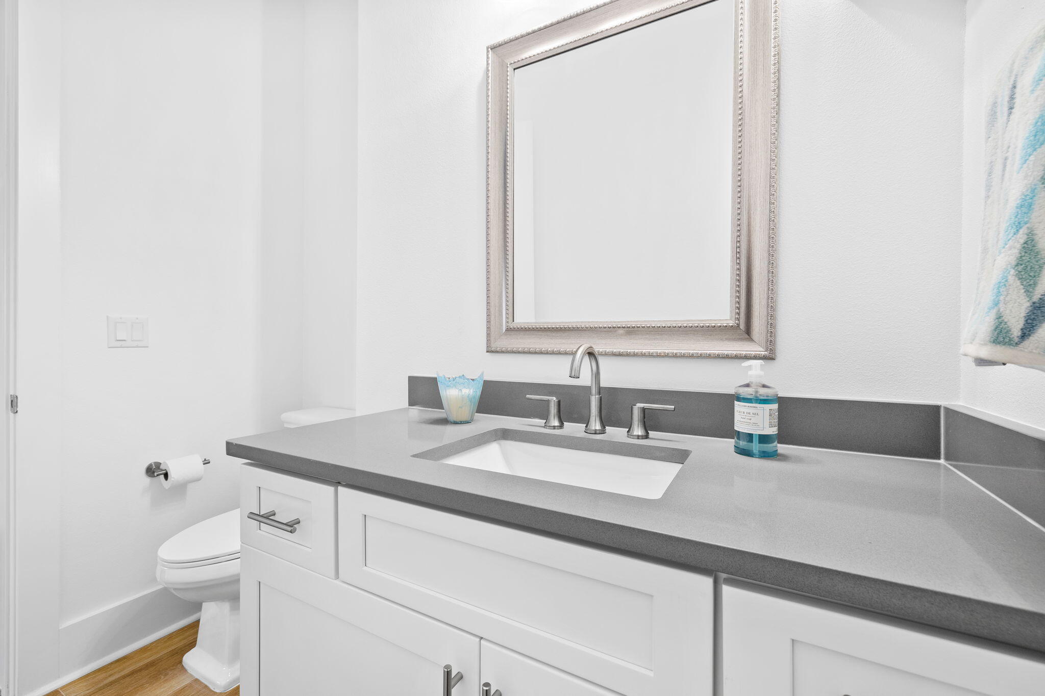 58 Carefree Lane Santa Rosa Beach, FL 32459 - Photo 22 of 44 a bathroom with a granite countertop toilet sink and mirror