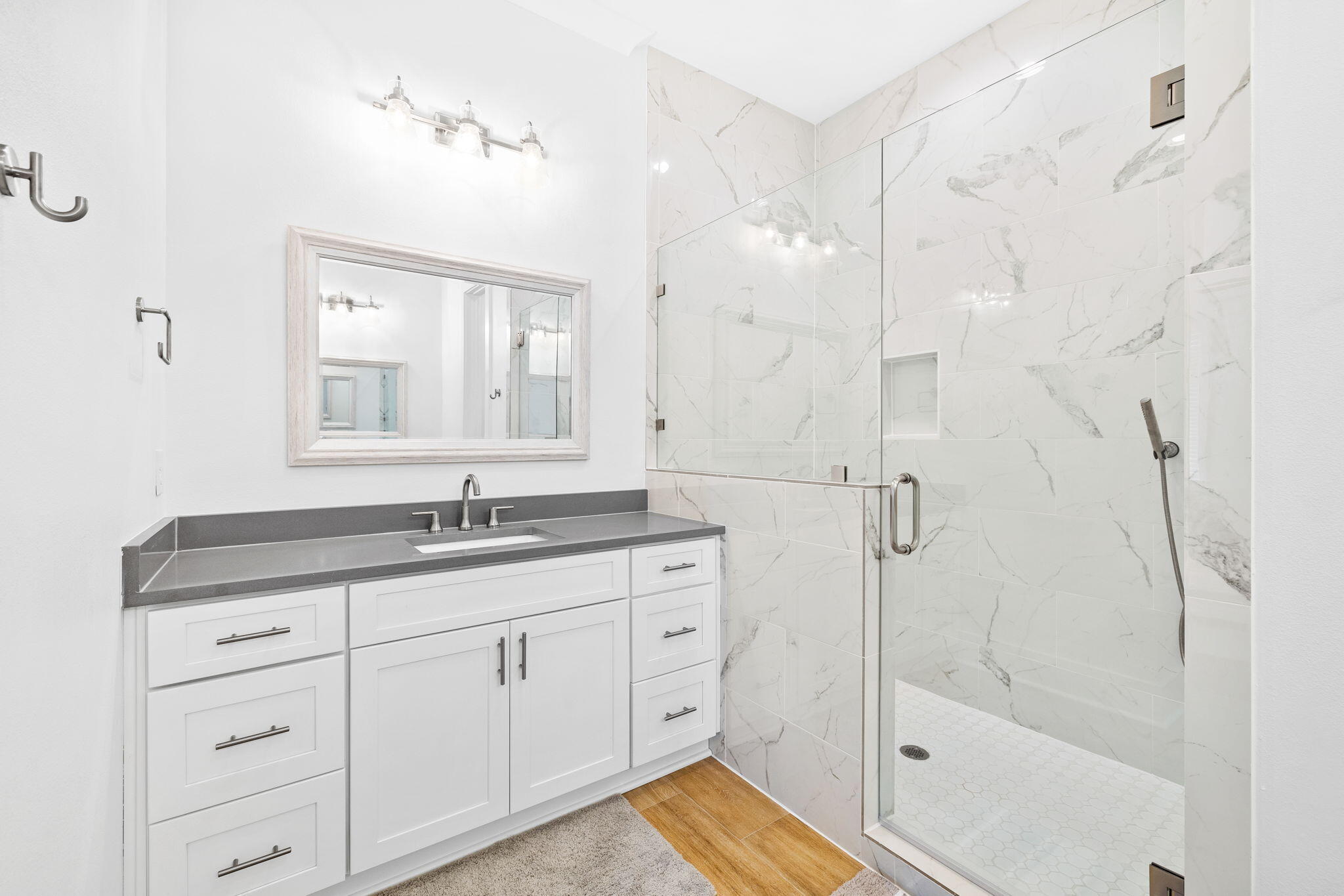 58 Carefree Lane Santa Rosa Beach, FL 32459 - Photo 30 of 44 a bathroom with a granite countertop sink a mirror a vanity and a bathtub