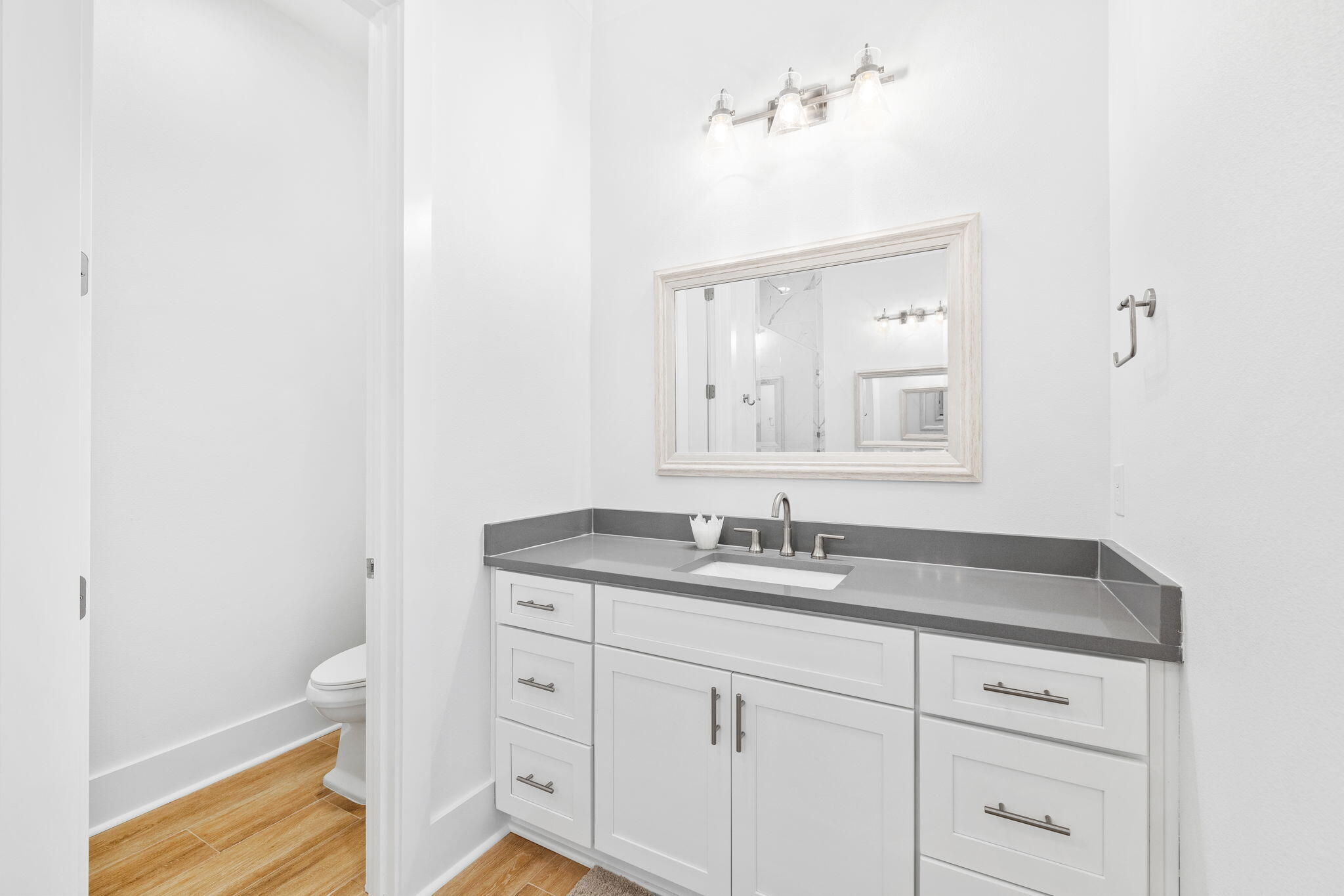58 Carefree Lane Santa Rosa Beach, FL 32459 - Photo 32 of 44 a bathroom with a granite countertop sink a toilet and a mirror