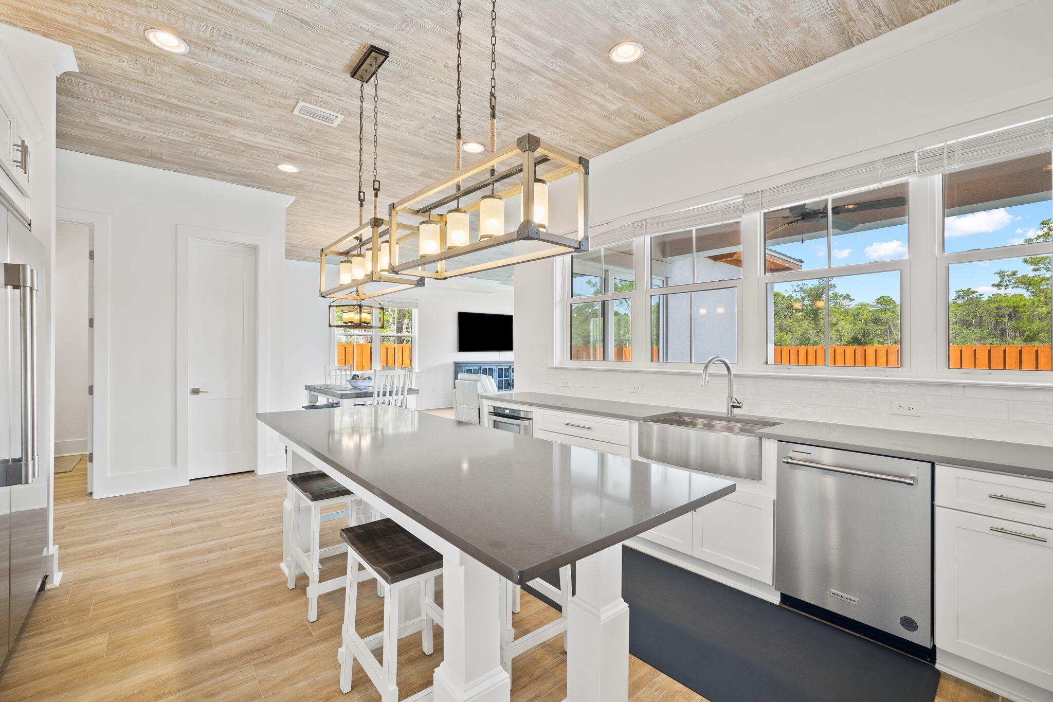 58 Carefree Lane Santa Rosa Beach, FL 32459 - Photo 5 of 44 a kitchen with kitchen island granite countertop a sink a center island and wooden floor