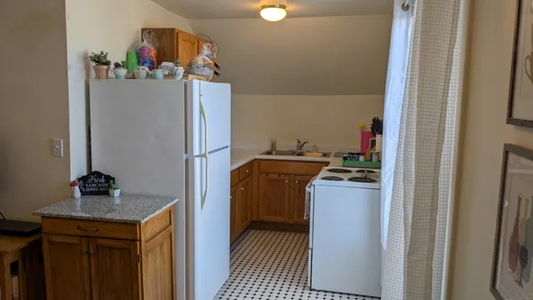 a kitchen with a refrigerator and a stove
