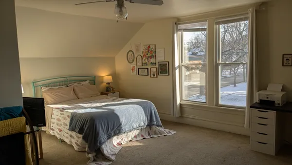 a bed sitting in a bedroom next to a window