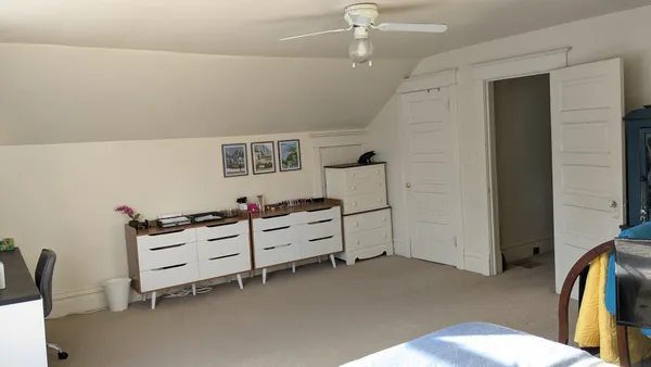 a bed room with furniture and white walls