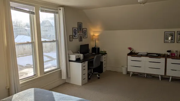 a view of a workspace with furniture and windows