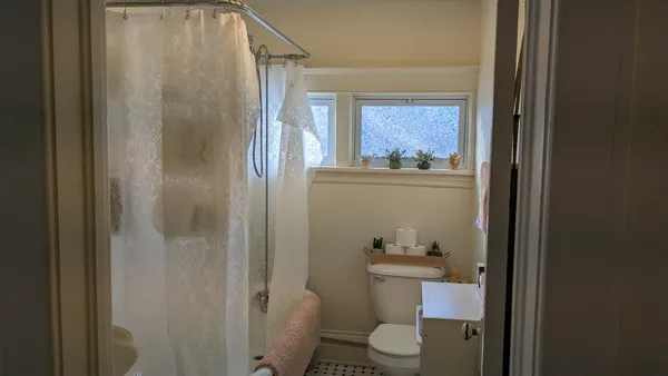 a bathroom with a toilet a sink and shower