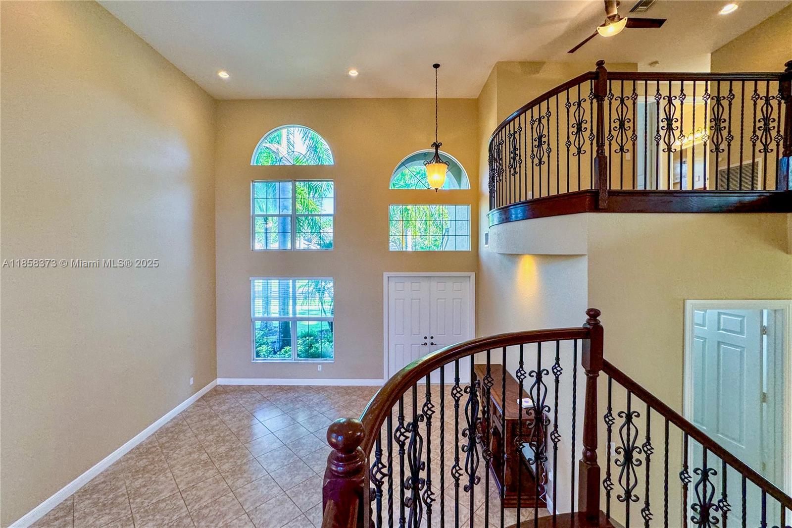 11894 Fox Hill Circle Boynton Beach, FL 33473 - Photo 13 of 35 a view of entryway with wooden floor and windows