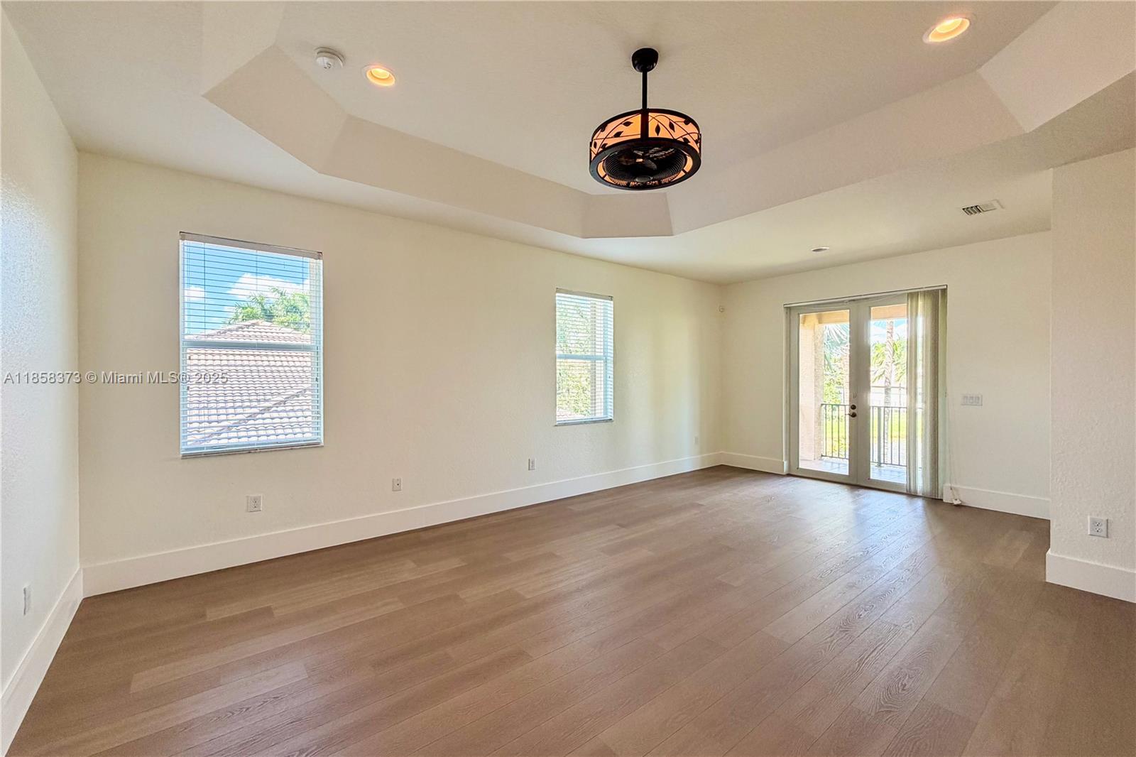 11894 Fox Hill Circle Boynton Beach, FL 33473 - Photo 15 of 35 a view of an empty room with window and wooden floor