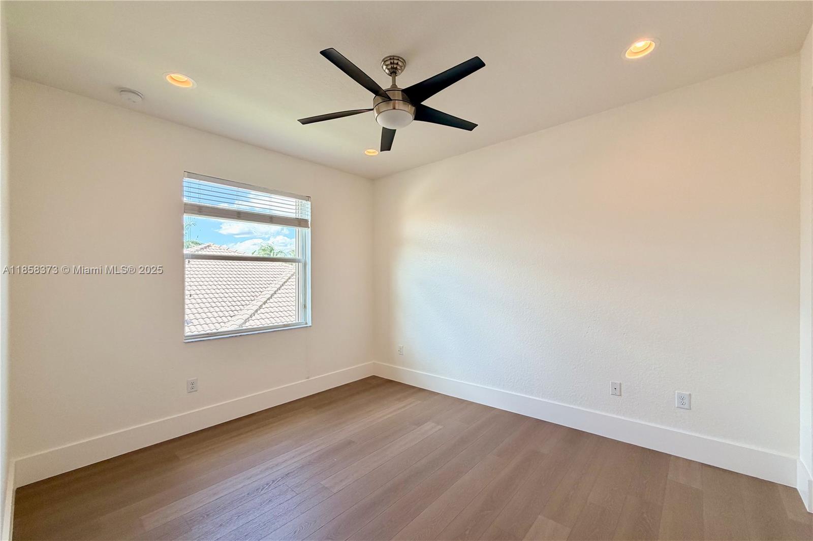11894 Fox Hill Circle Boynton Beach, FL 33473 - Photo 24 of 35 an empty room with wooden floor and ceiling fan