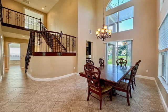 a view of a dining room with furniture and a chandelier