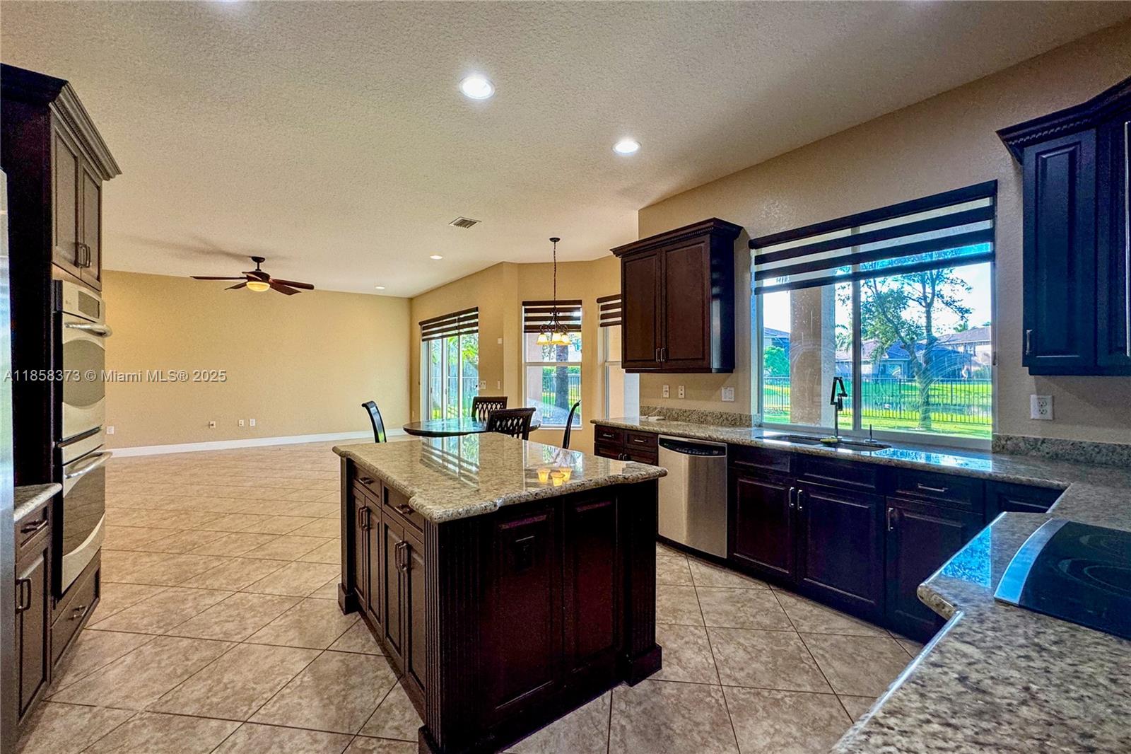 11894 Fox Hill Circle Boynton Beach, FL 33473 - Photo 8 of 35 a kitchen with a stove sink and cabinets