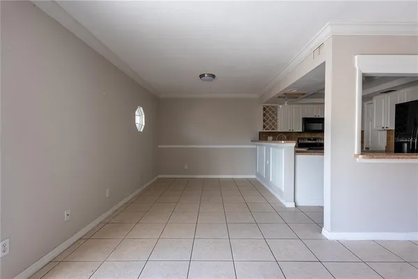 a kitchen with white cabinets and refrigerator