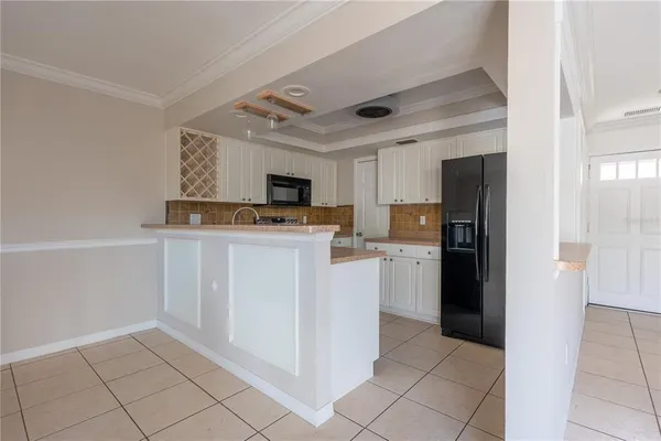 a kitchen with a sink appliances and cabinets