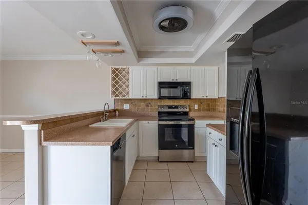 a kitchen with stainless steel appliances a refrigerator and cabinets