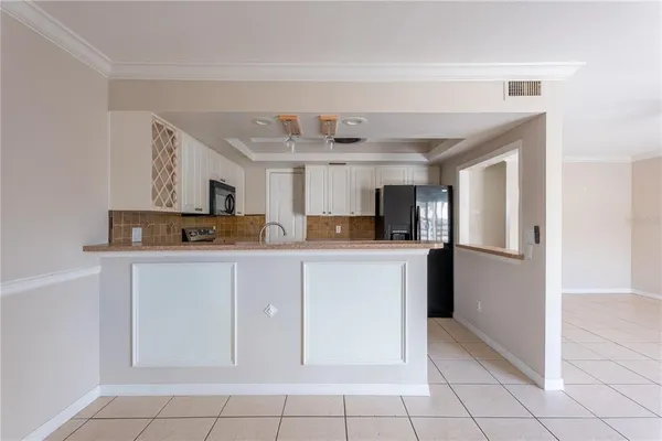 a view of a kitchen with a sink and cabinet