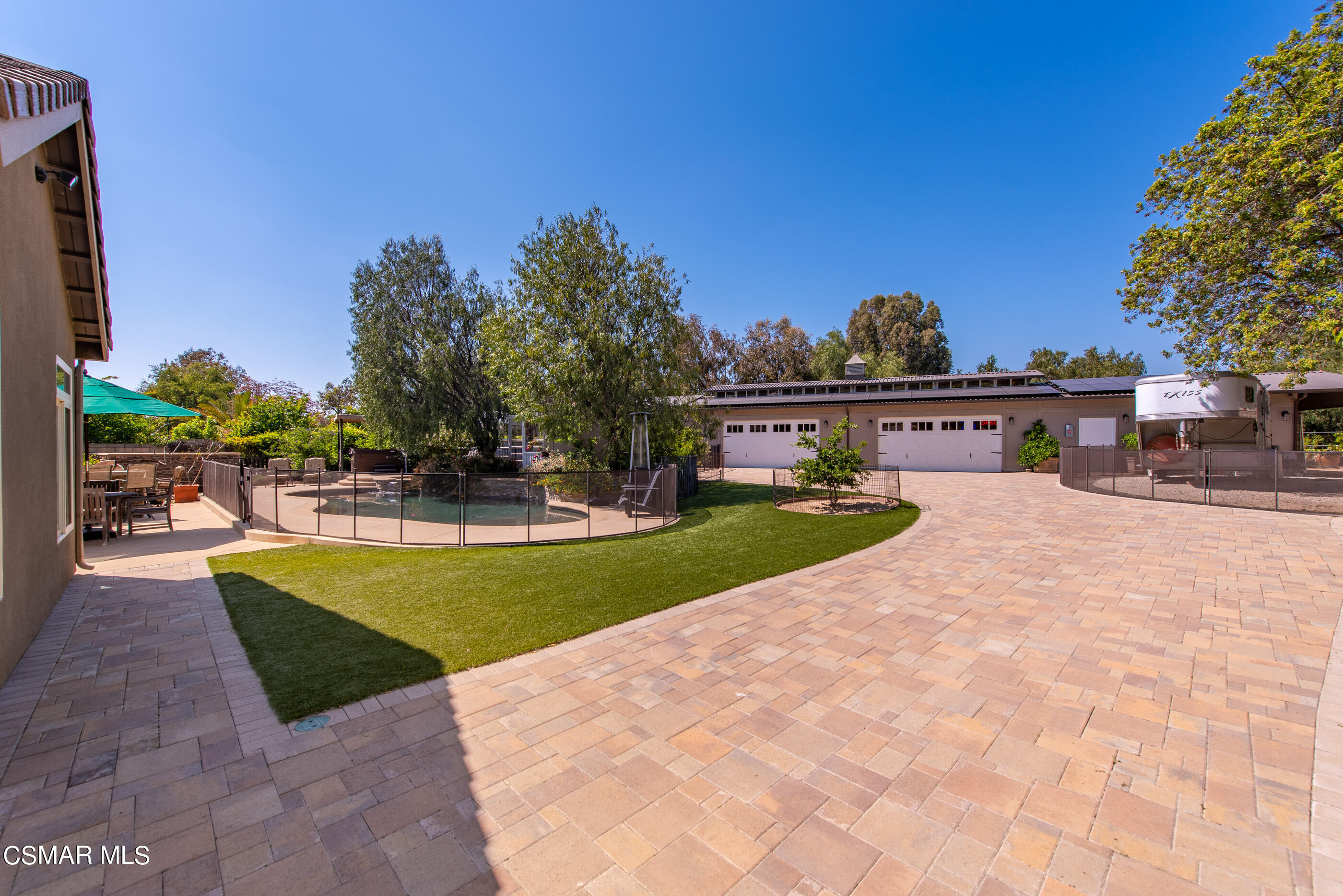 525 Aqueduct Court Simi Valley, CA 93065 - Photo 78 of 98 a view of a swimming pool with a table and chairs under an umbrella