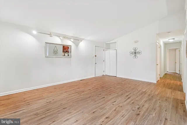 a view of empty room with wooden floor