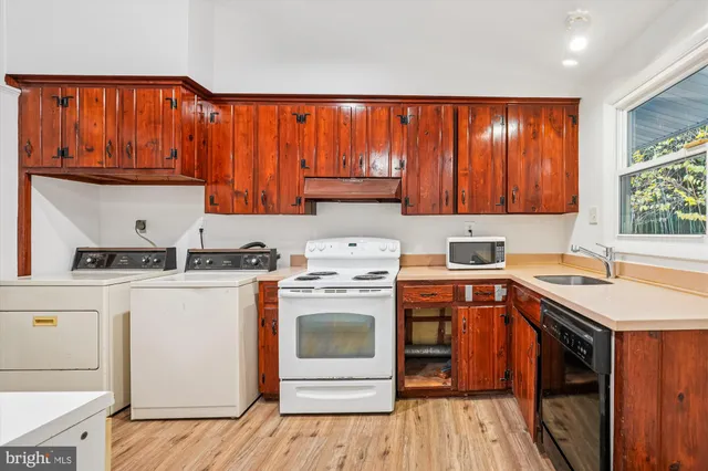 a kitchen with a stove top oven sink and cabinets