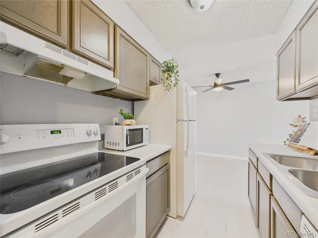 a kitchen with stainless steel appliances granite countertop a sink and cabinets