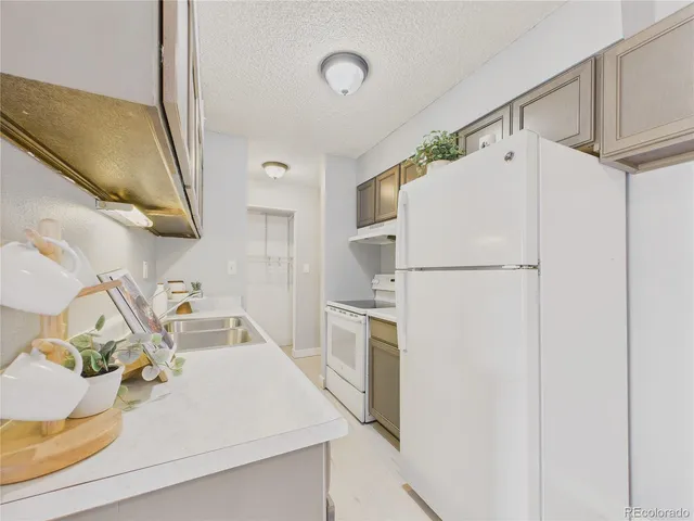 a white refrigerator freezer sitting inside of a kitchen