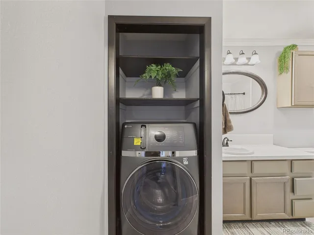 a bathroom with a sink mirror vanity and toilet