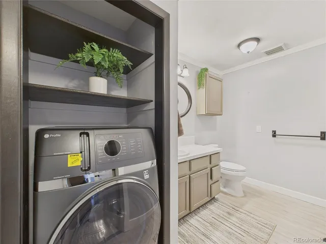 a bathroom with a double vanity sink mirror and toilet