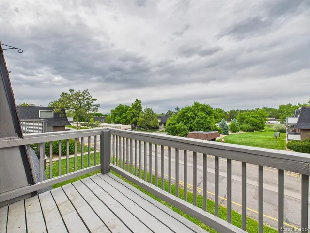 a view of a house with a yard and large tree
