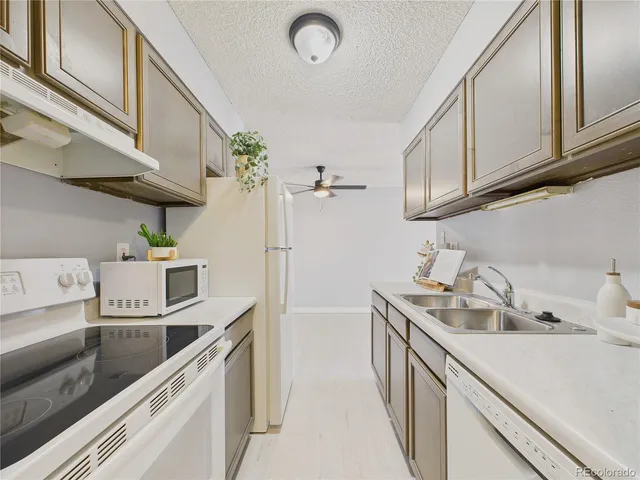 a kitchen with a sink a stove and cabinets