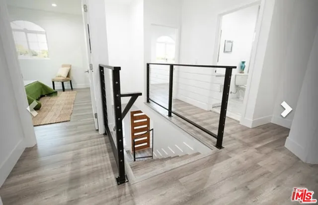 a view of entryway with wooden floor and stairs