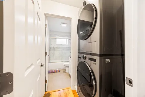 a view of a bedroom with washer and dryer