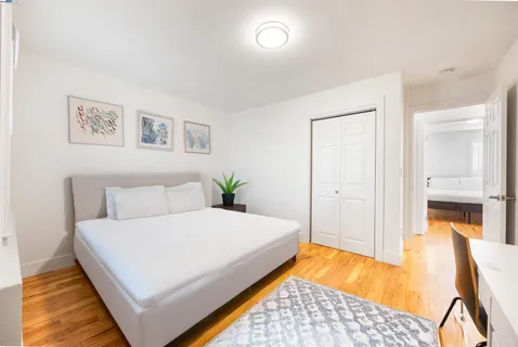 a bedroom with a bed and a lamp on table