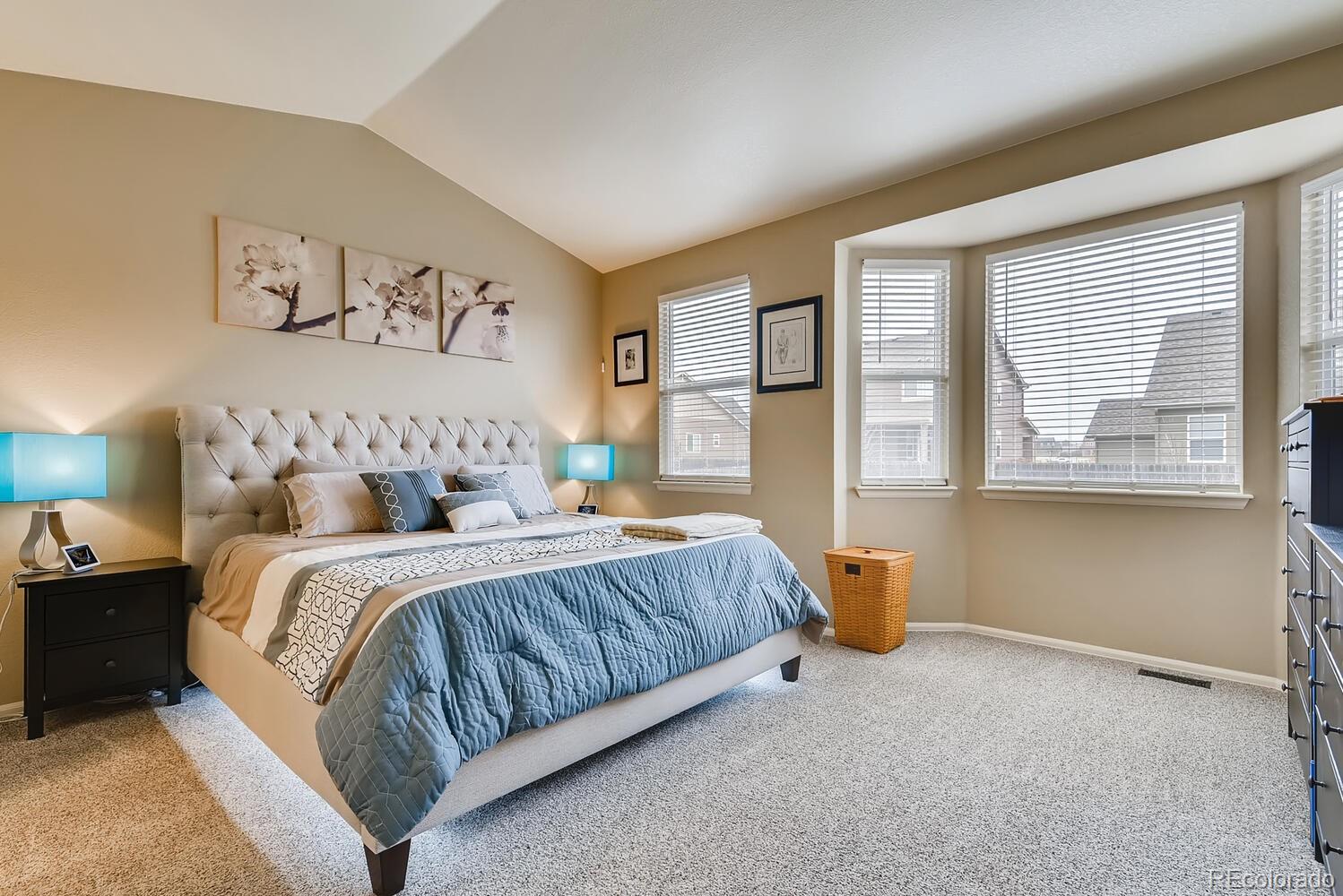 8413 Raspberry Drive Frederick, CO 80504 - Photo 12 of 27 a bedroom with a bed and wooden floor