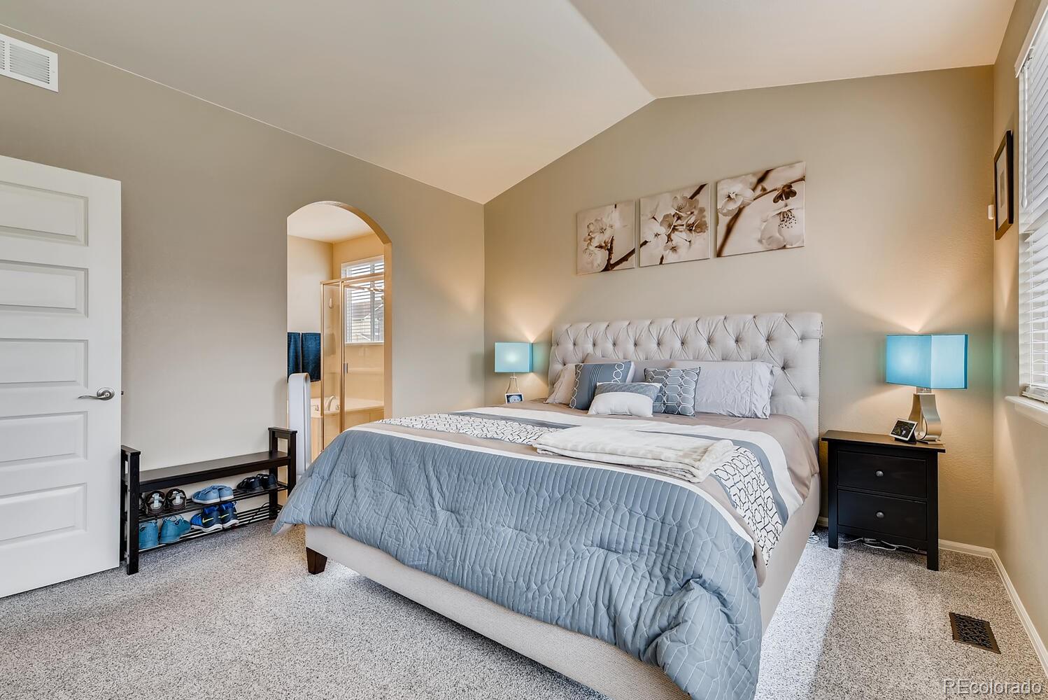 8413 Raspberry Drive Frederick, CO 80504 - Photo 13 of 27 a bedroom with a bed and a lamp
