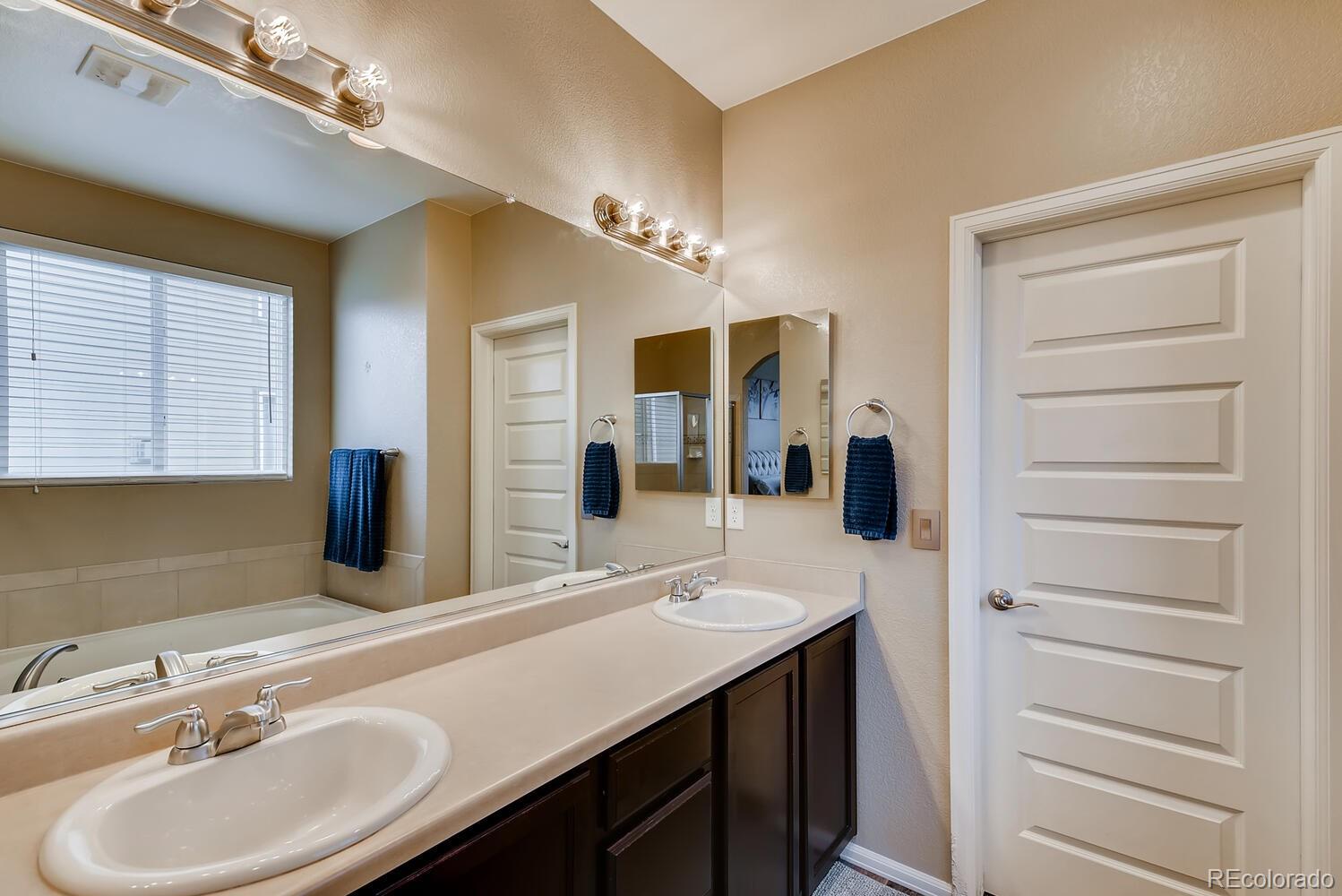 8413 Raspberry Drive Frederick, CO 80504 - Photo 14 of 27 a bathroom with a sink double vanity and a mirror