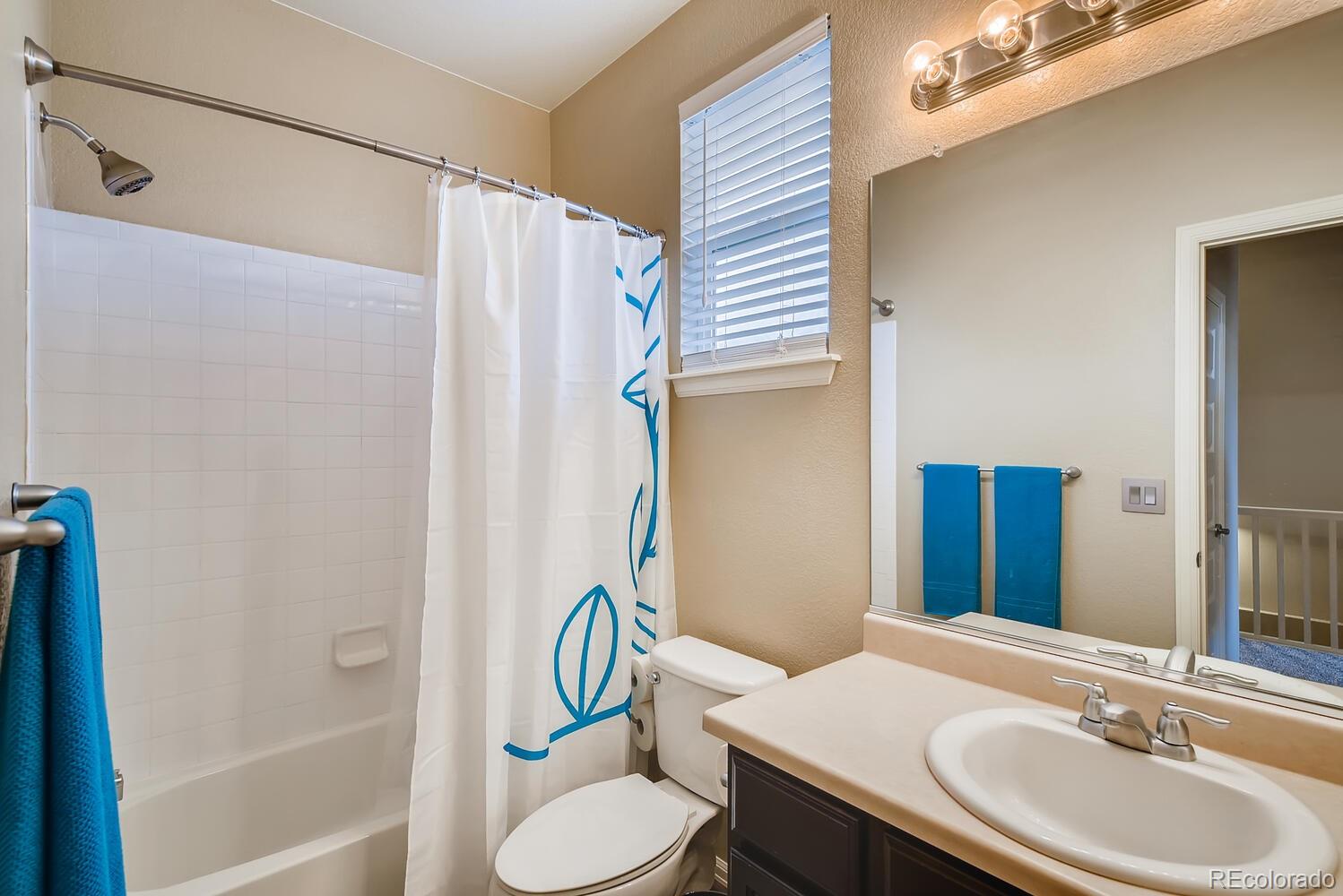 8413 Raspberry Drive Frederick, CO 80504 - Photo 17 of 27 a bathroom with a sink toilet and shower