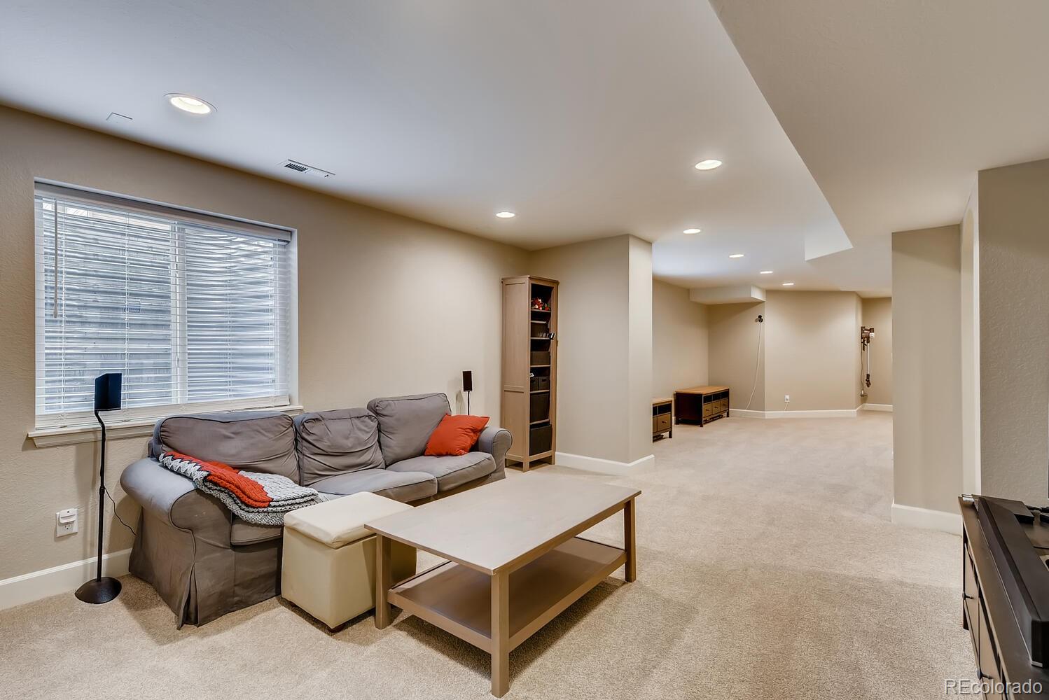 8413 Raspberry Drive Frederick, CO 80504 - Photo 18 of 27 a living room with furniture a window and a table