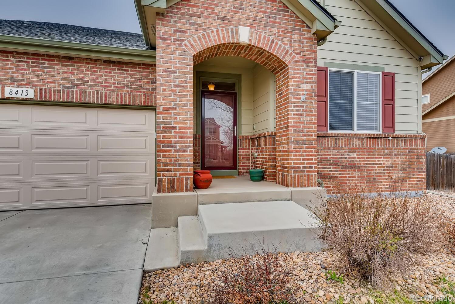 8413 Raspberry Drive Frederick, CO 80504 - Photo 2 of 27 a view of a brick house with many windows